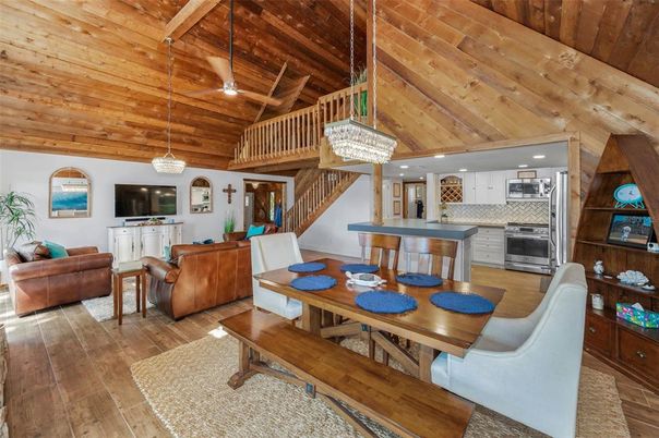 Chandelier, Dining room, Interior, Kitchen, Living room, Pendant Lights, Recessed Lighting, Stainless Steel Appliances, Wooden Beams, Wooden Ceilings, Wood Texture Flooring