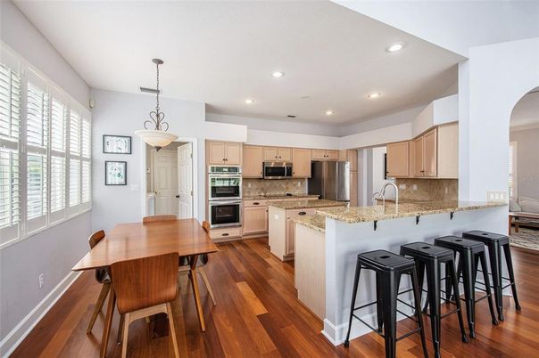 Dining room, Interior, Kitchen, Pendant Lights, Recessed Lighting, Stainless Steel Appliances, Wood Texture Flooring
