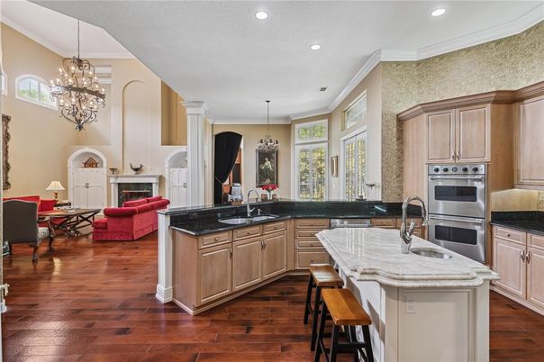Chandelier, Dining room, Fireplace, Interior, Kitchen, Living room, Pendant Lights, Recessed Lighting, Stainless Steel Appliances, Wood Texture Flooring