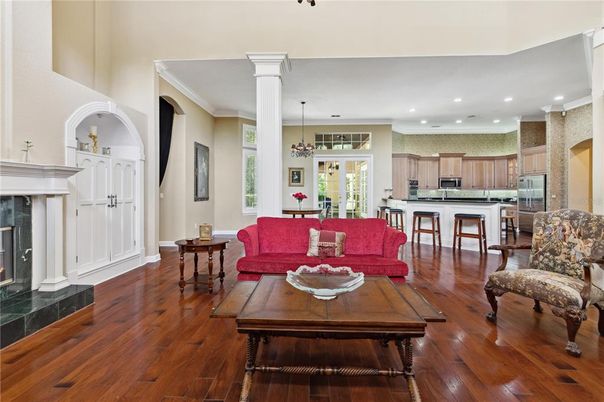 Chandelier, Dining room, Fireplace, Interior, Kitchen, Living room, Pendant Lights, Recessed Lighting, Stainless Steel Appliances, Wood Texture Flooring