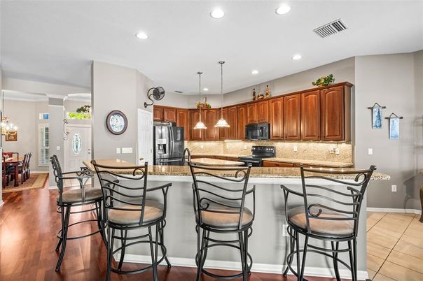 Chandelier, Dining room, Interior, Kitchen, Pendant Lights, Recessed Lighting, Stainless Steel Appliances, Wood Texture Flooring