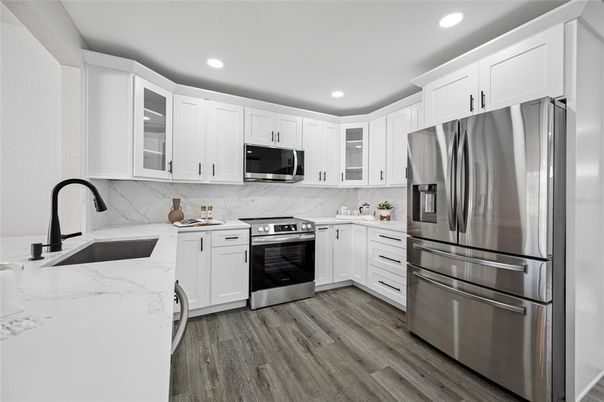 Interior, Kitchen, Marble Walls, Recessed Lighting, Stainless Steel Appliances, Wood Texture Flooring