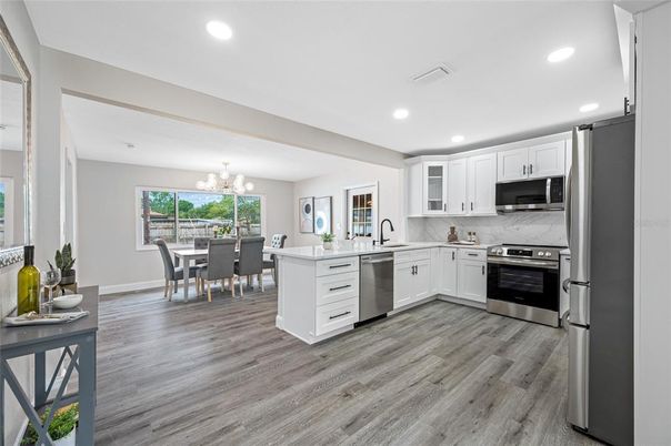 Chandelier, Dining room, Interior, Kitchen, Recessed Lighting, Stainless Steel Appliances, Wood Texture Flooring