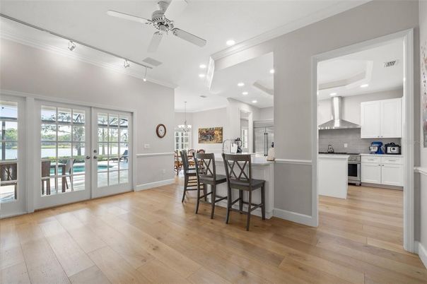 Chandelier, Dining room, Interior, Kitchen, Pendant Lights, Recessed Lighting, Stainless Steel Appliances, Wood Texture Flooring