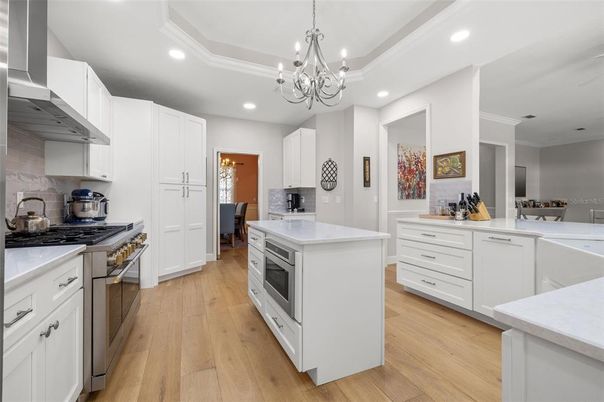 Chandelier, Dining room, Interior, Kitchen, Recessed Lighting, Stainless Steel Appliances, Wood Texture Flooring