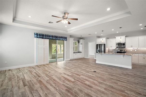 Empty room, Interior, Kitchen, Pendant Lights, Recessed Lighting, Stainless Steel Appliances, Wood Texture Flooring