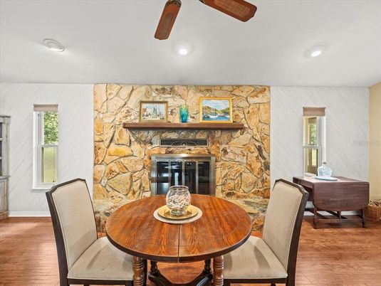 Dining room, Fireplace, Interior, Recessed Lighting, Stone Walls, Wood Texture Flooring