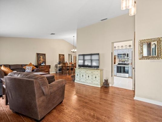 Chandelier, Dining room, Interior, Kitchen, Living room, Stainless Steel Appliances, Wood Texture Flooring