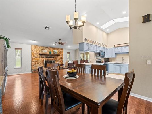 Chandelier, Dining room, Fireplace, Interior, Kitchen, Recessed Lighting, Stone Walls, Wood Texture Flooring