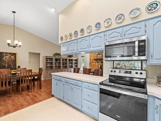 Chandelier, Dining room, Interior, Kitchen, Recessed Lighting, Stainless Steel Appliances, Wood Texture Flooring