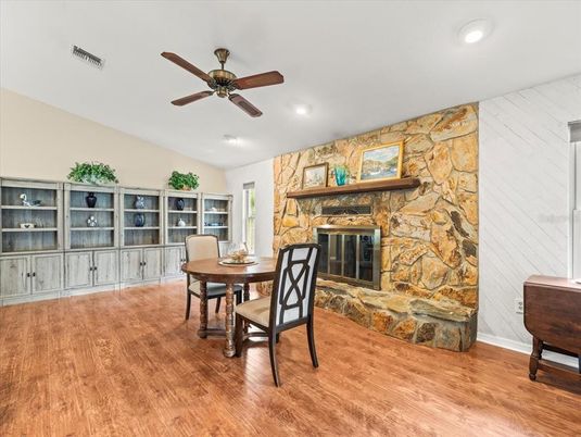 Dining room, Fireplace, Interior, Recessed Lighting, Stone Walls, Wood Texture Flooring