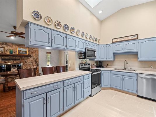 Dining room, Interior, Kitchen, Recessed Lighting, Stainless Steel Appliances, Stone Walls, Wood Texture Flooring