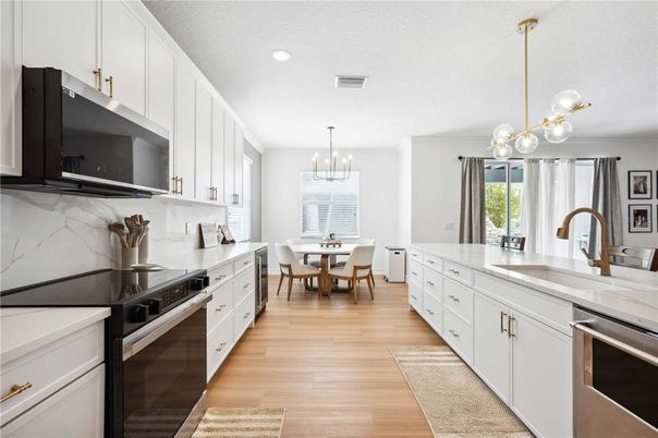 Chandelier, Dining room, Interior, Kitchen, Pendant Lights, Recessed Lighting, Stainless Steel Appliances, Wood Texture Flooring