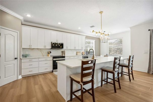 Interior, Kitchen, Marble Walls, Pendant Lights, Recessed Lighting, Stainless Steel Appliances, Wood Texture Flooring