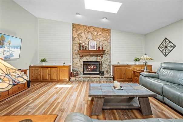 Fireplace, Interior, Living room, Recessed Lighting, Stone Walls, Wood Texture Flooring