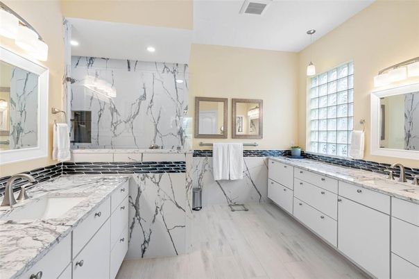 Bathroom, Dual Sink Vanities, Interior, Marble Walls, Pendant Lights, Recessed Lighting, Wood Texture Flooring