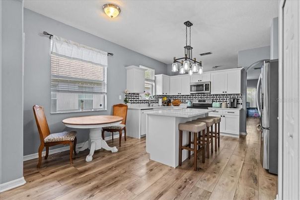 Dining room, Interior, Kitchen, Pendant Lights, Stainless Steel Appliances, Wood Texture Flooring