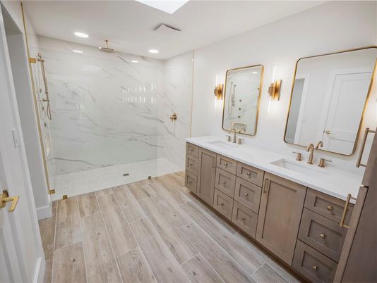 Bathroom, Dual Sink Vanities, Interior, Marble Walls, Recessed Lighting, Wood Texture Flooring