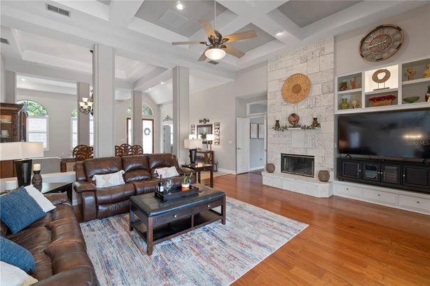 Dining room, Fireplace, Interior, Living room, Recessed Lighting, Stone Walls, Wood Texture Flooring