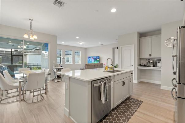 Chandelier, Dining room, Interior, Kitchen, Living room, Pendant Lights, Recessed Lighting, Stainless Steel Appliances, Wood Texture Flooring