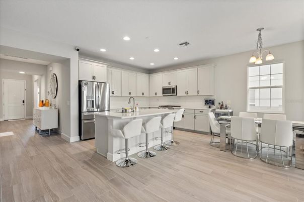 Dining room, Interior, Kitchen, Pendant Lights, Recessed Lighting, Stainless Steel Appliances, Wood Texture Flooring