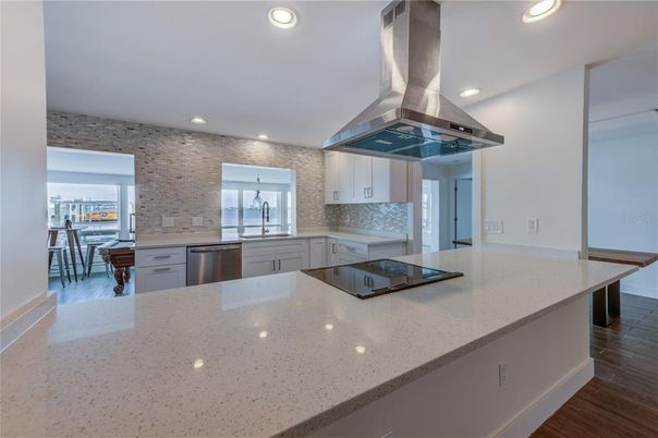 Dining room, Interior, Kitchen, Recessed Lighting, Stainless Steel Appliances, Stone Walls, Wood Texture Flooring