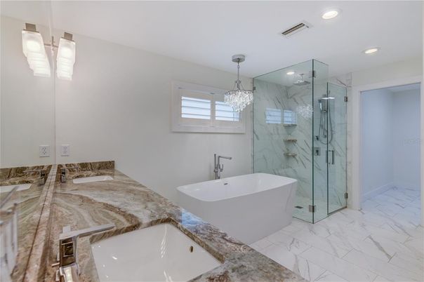 Bathroom, Chandelier, Dual Sink Vanities, Free Standing Baths, Glass Shower, Interior, Marble, Marble Walls, Pendant Lights, Recessed Lighting