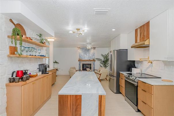 Fireplace, Interior, Kitchen, Recessed Lighting, Stainless Steel Appliances, Wood Texture Flooring