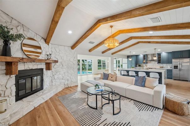 Fireplace, Interior, Kitchen, Living room, Pendant Lights, Recessed Lighting, Stainless Steel Appliances, Stone Walls, Wooden Beams, Wood Texture Flooring