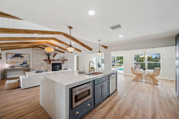 Dining room, Fireplace, Interior, Kitchen, Living room, Pendant Lights, Recessed Lighting, Stainless Steel Appliances, Stone Walls, Wooden Beams, Wood Texture Flooring