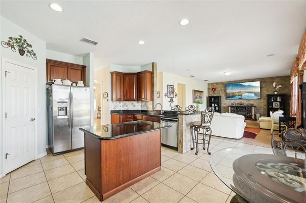 Fireplace, Interior, Kitchen, Living room, Recessed Lighting, Stainless Steel Appliances, Stone Walls
