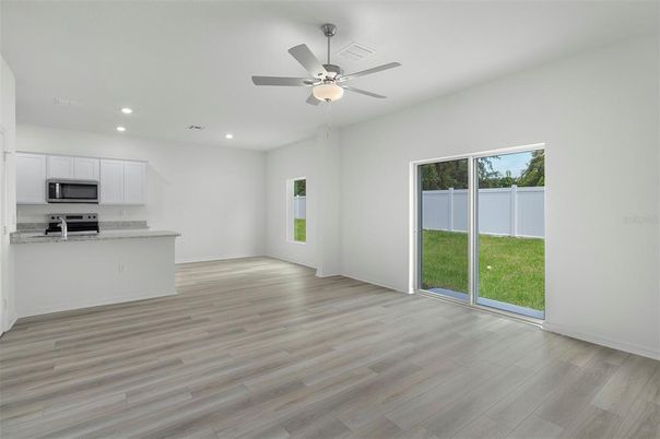 Empty room, Interior, Kitchen, Recessed Lighting, Stainless Steel Appliances, Wood Texture Flooring