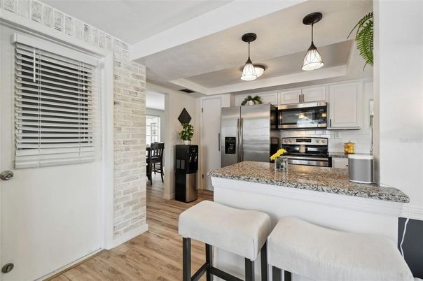 Interior, Kitchen, Pendant Lights, Stainless Steel Appliances, Stone Walls, Wood Texture Flooring