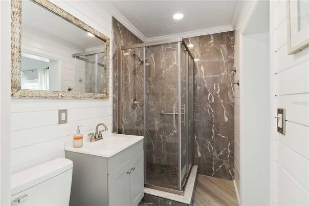 Bathroom, Glass Shower, Interior, Marble Walls, Recessed Lighting, Wood Texture Flooring