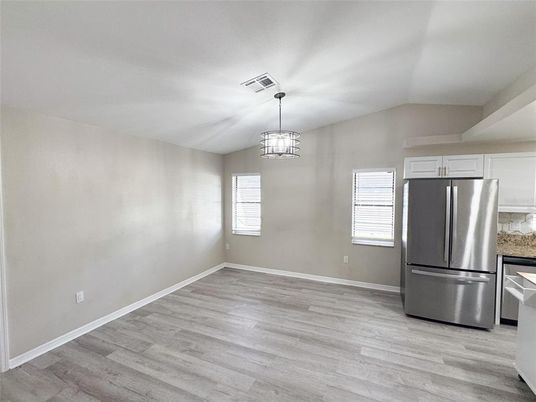 Empty room, Interior, Kitchen, Pendant Lights, Stainless Steel Appliances, Wood Texture Flooring