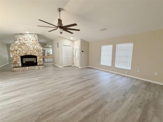 Empty room, Fireplace, Interior, Recessed Lighting, Stone Walls, Wood Texture Flooring