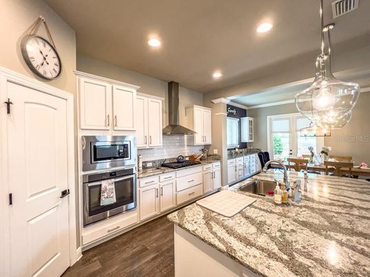 Dining room, Interior, Kitchen, Pendant Lights, Recessed Lighting, Stainless Steel Appliances, Wood Texture Flooring