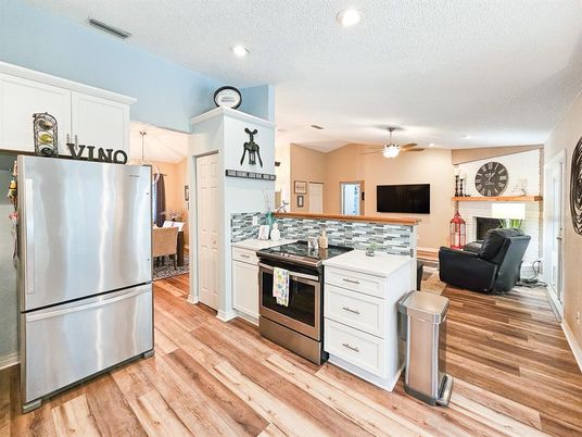 Fireplace, Interior, Kitchen, Recessed Lighting, Stainless Steel Appliances, Wood Texture Flooring