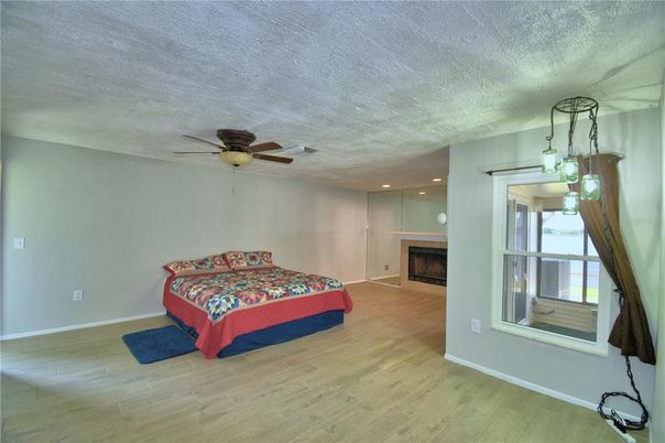 Bedroom, Fireplace, Interior, Pendant Lights, Recessed Lighting, Wood Texture Flooring