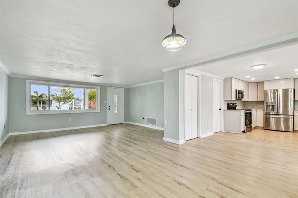 Empty room, Interior, Kitchen, Pendant Lights, Recessed Lighting, Stainless Steel Appliances, Wood Texture Flooring