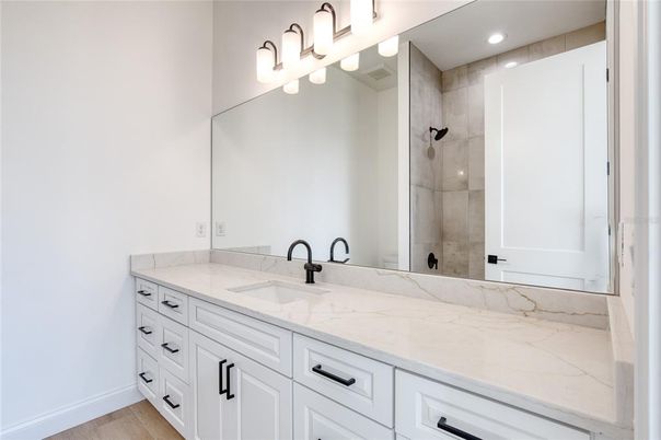 Bathroom, Dual Sink Vanities, Glass Shower, Interior, Recessed Lighting, Wood Texture Flooring