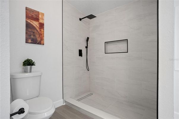 Bathroom, Glass Shower, Interior, Marble Walls, Wood Texture Flooring