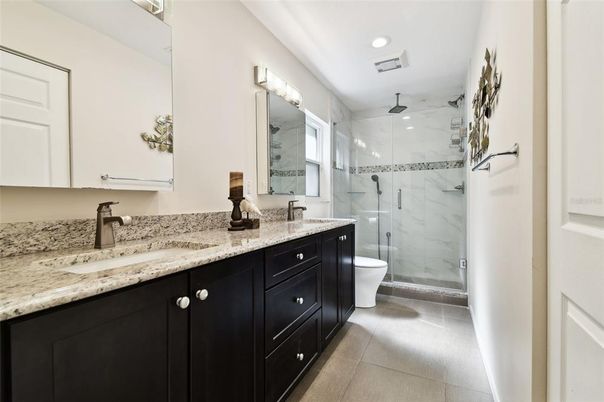 Bathroom, Dual Sink Vanities, Free Standing Baths, Glass Shower, Interior, Marble Walls, Recessed Lighting