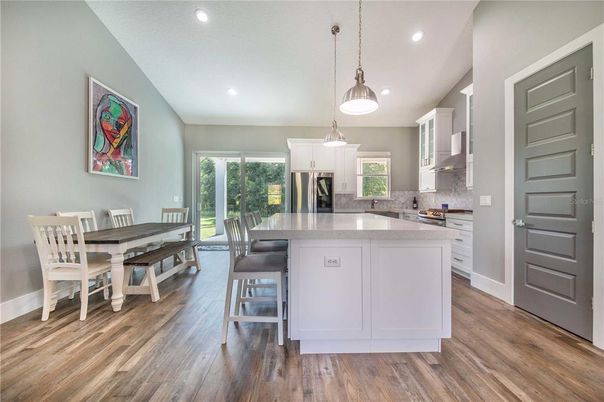 Dining room, Interior, Kitchen, Pendant Lights, Recessed Lighting, Stainless Steel Appliances, Wood Texture Flooring