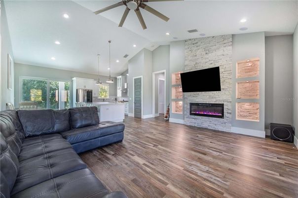 Fireplace, Interior, Kitchen, Living room, Pendant Lights, Recessed Lighting, Stainless Steel Appliances, Stone Walls, Wood Texture Flooring