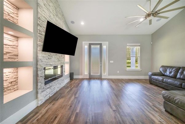 Empty room, Fireplace, Interior, Recessed Lighting, Stone Walls, Wood Texture Flooring