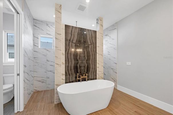 Bathroom, Free Standing Baths, Interior, Marble Walls, Recessed Lighting, Wood Texture Flooring