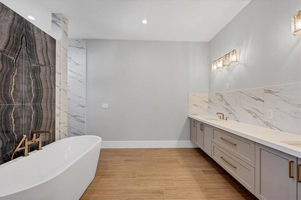 Bathroom, Dual Sink Vanities, Free Standing Baths, Interior, Marble Walls, Recessed Lighting, Wood Texture Flooring
