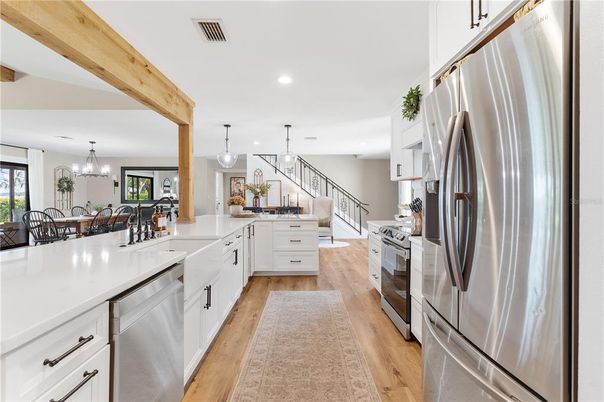 Chandelier, Dining room, Interior, Kitchen, Pendant Lights, Recessed Lighting, Stainless Steel Appliances, Wooden Beams, Wood Texture Flooring