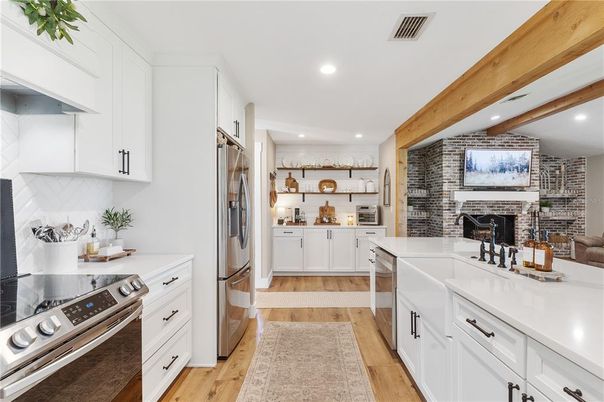 Fireplace, Interior, Kitchen, Recessed Lighting, Stainless Steel Appliances, Stone Walls, Wooden Beams, Wood Texture Flooring